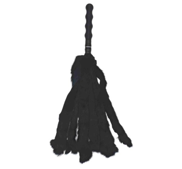 Black bunny fur flogger on white background.