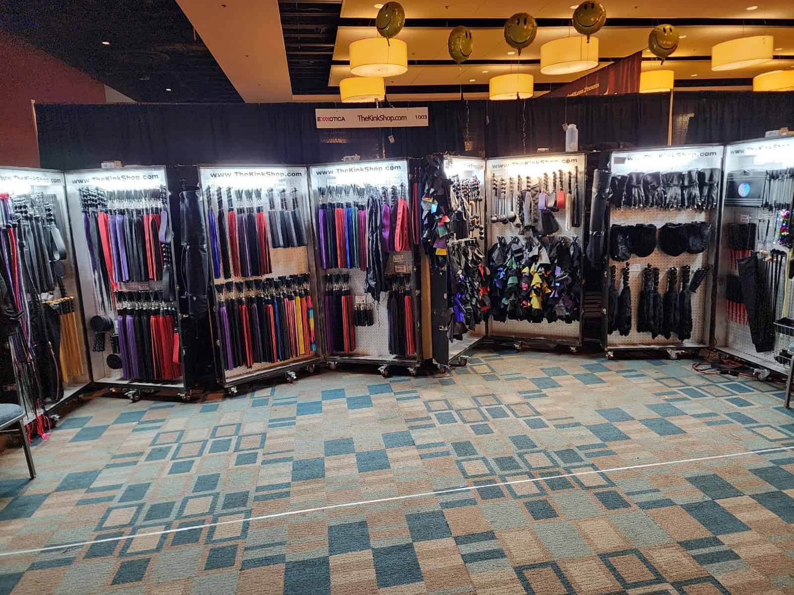 The Kink Shop item cases set up at a road show. 2 cases contain many kink toys.