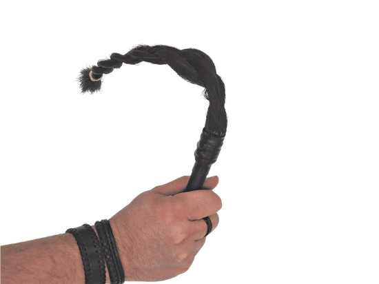 Picture of a hand holding a nutcracker BDSM pocket hair flogger whip
