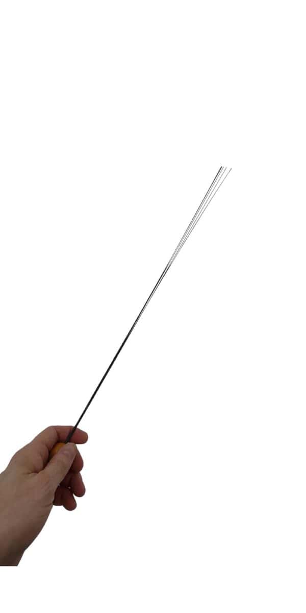 Hand holding a BDSM cane made out of black carbon fiber on a white background